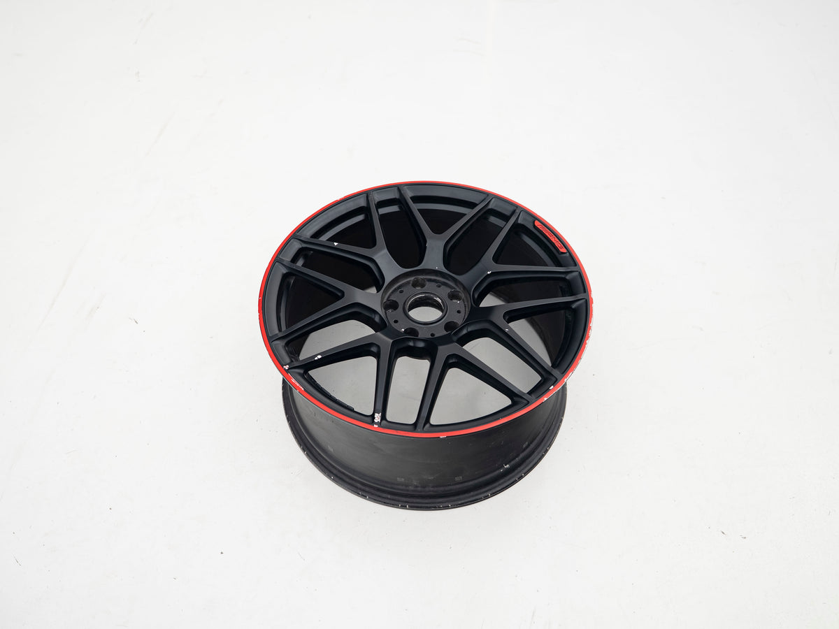 AMG 22-inch wheel, black face and red lip — actual stock photograph