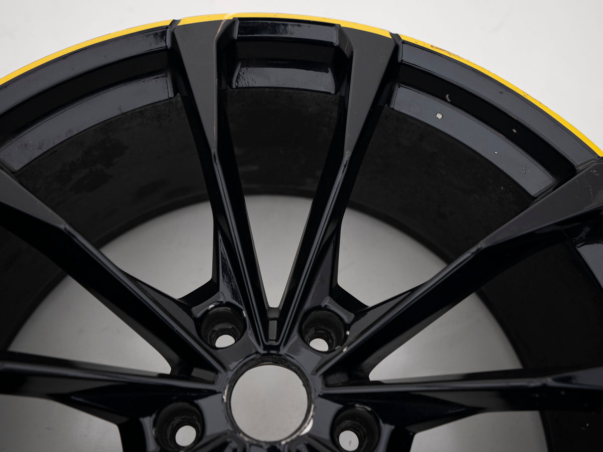 Used Lamborghini Urus 23-inch wheel with black face and yellow outer edge