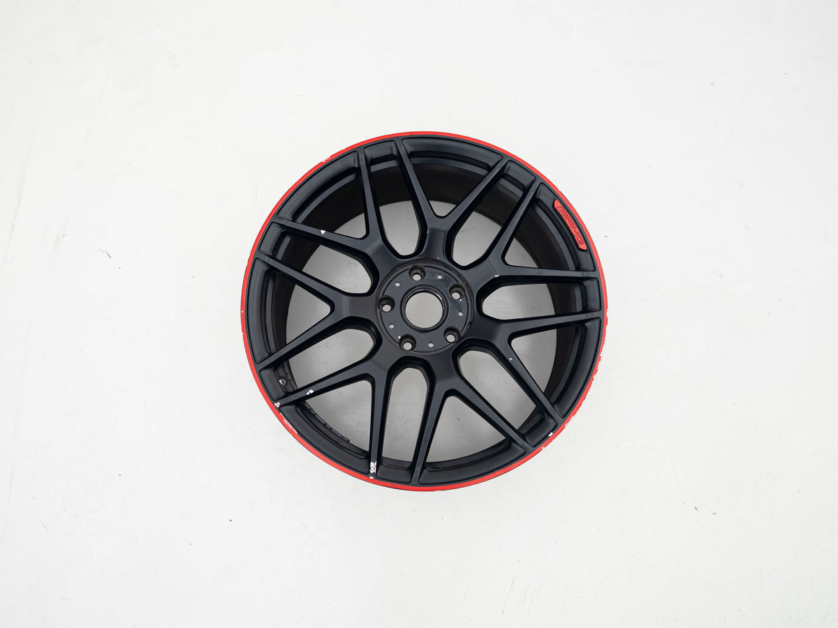 Used AMG 22-inch wheel with black face and red lip, front view