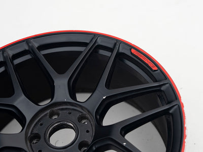 AMG 22-inch wheel, black face and red lip — actual stock photograph