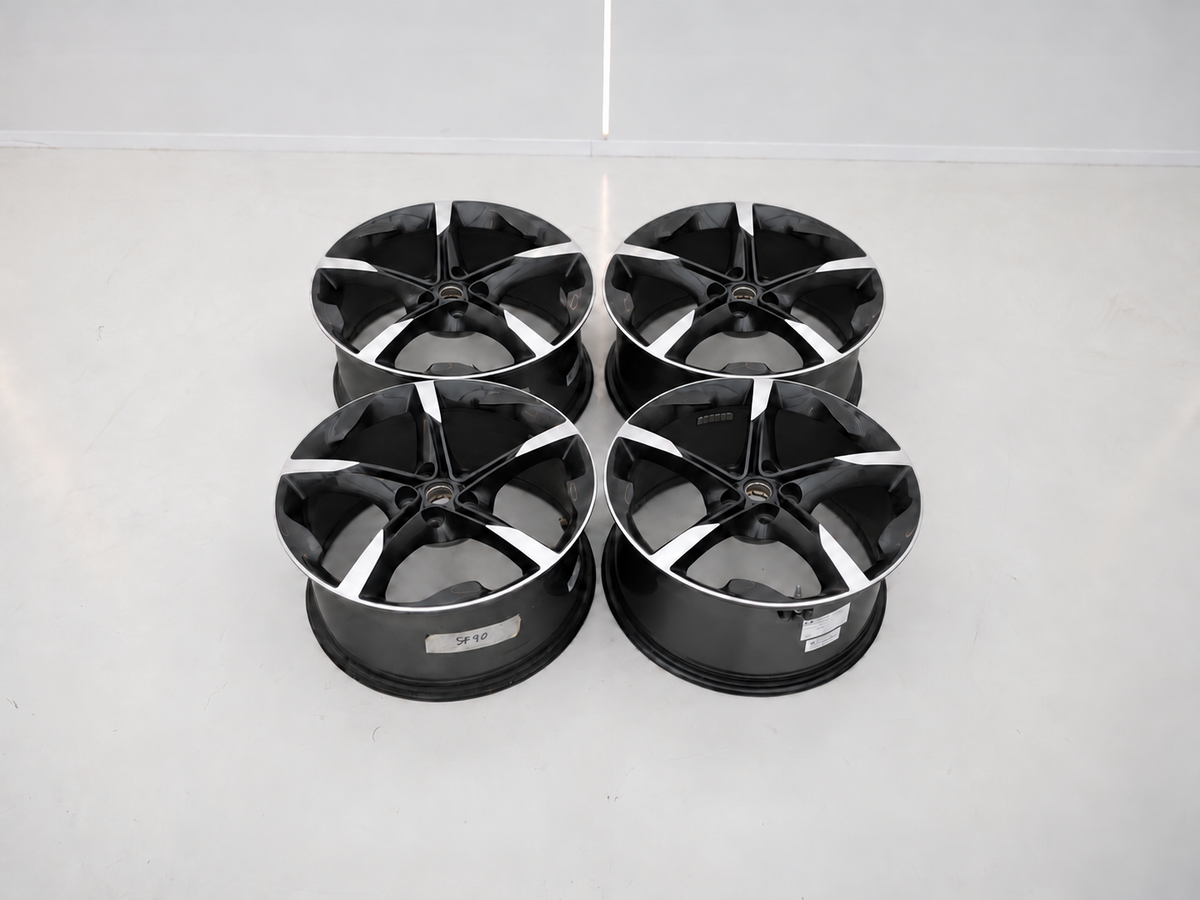 AI composite of the Ferrari SF90 four-wheel set, lying flat with two wheels of each spoke direction